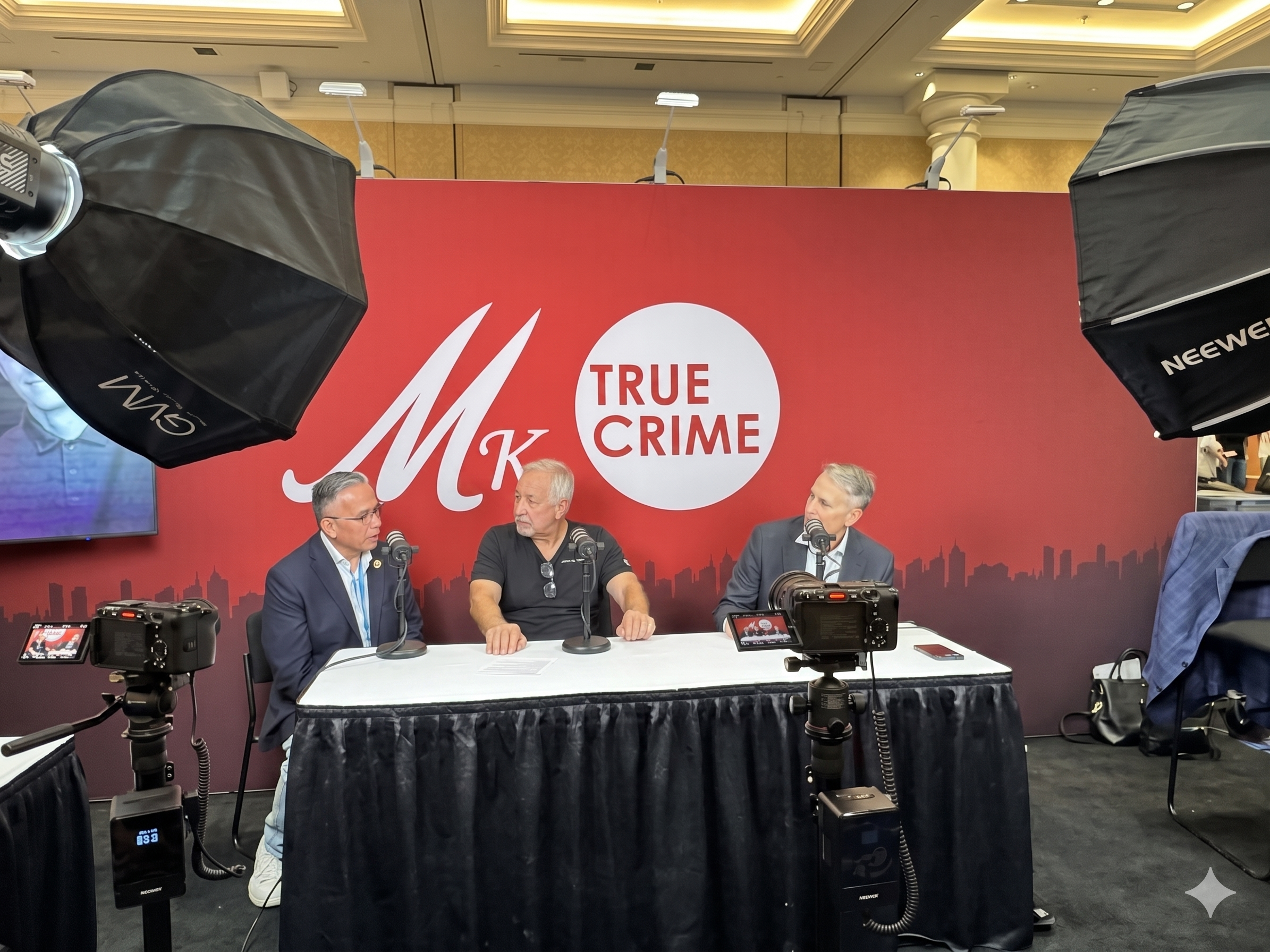 Moses Castillo seated for an on-camera interview at the MK True Crime booth during CRIMECON